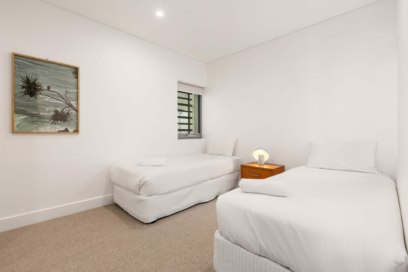 Bedroom with twin single beds and white linens