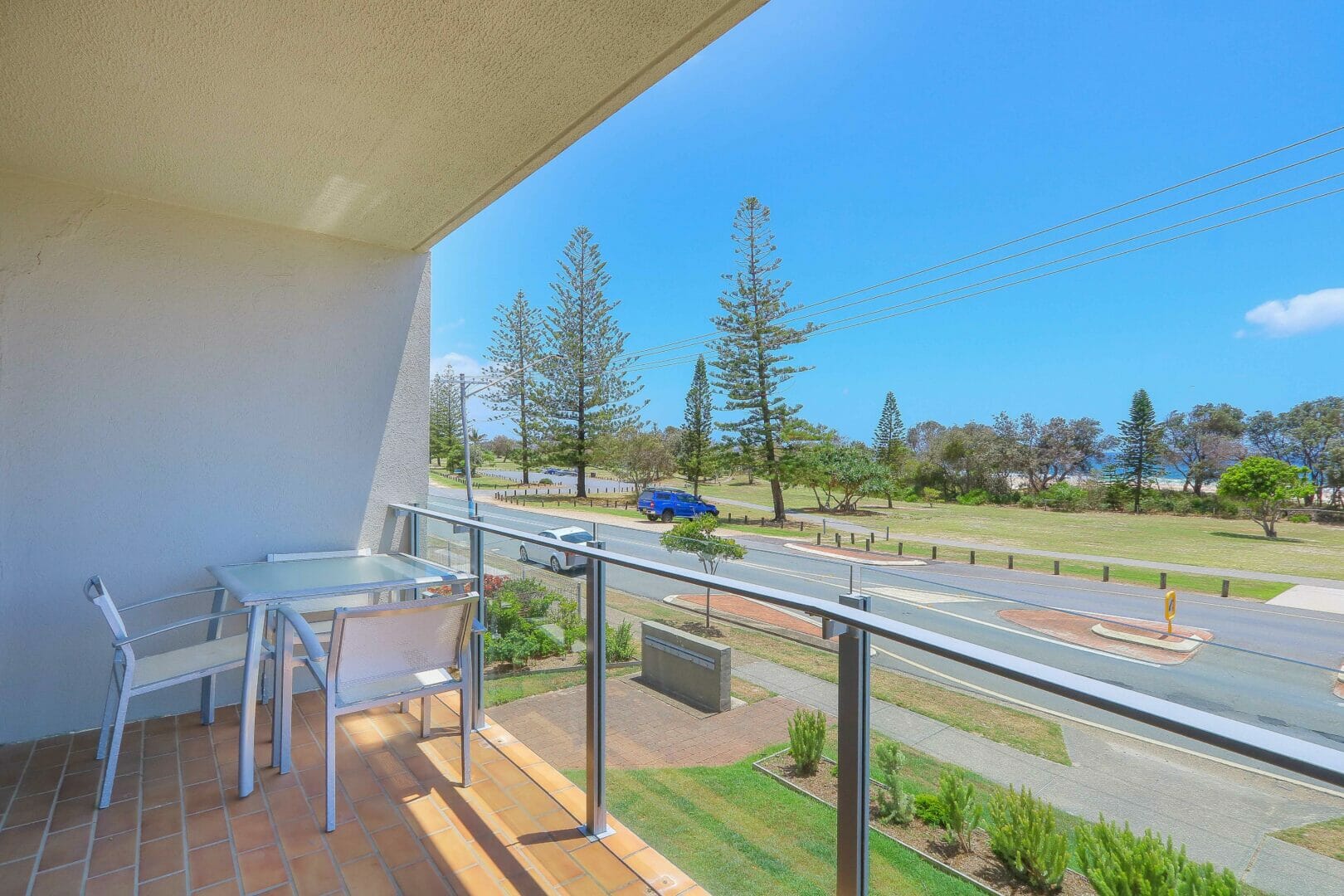 balcony with views of road, parkland and beachfront
