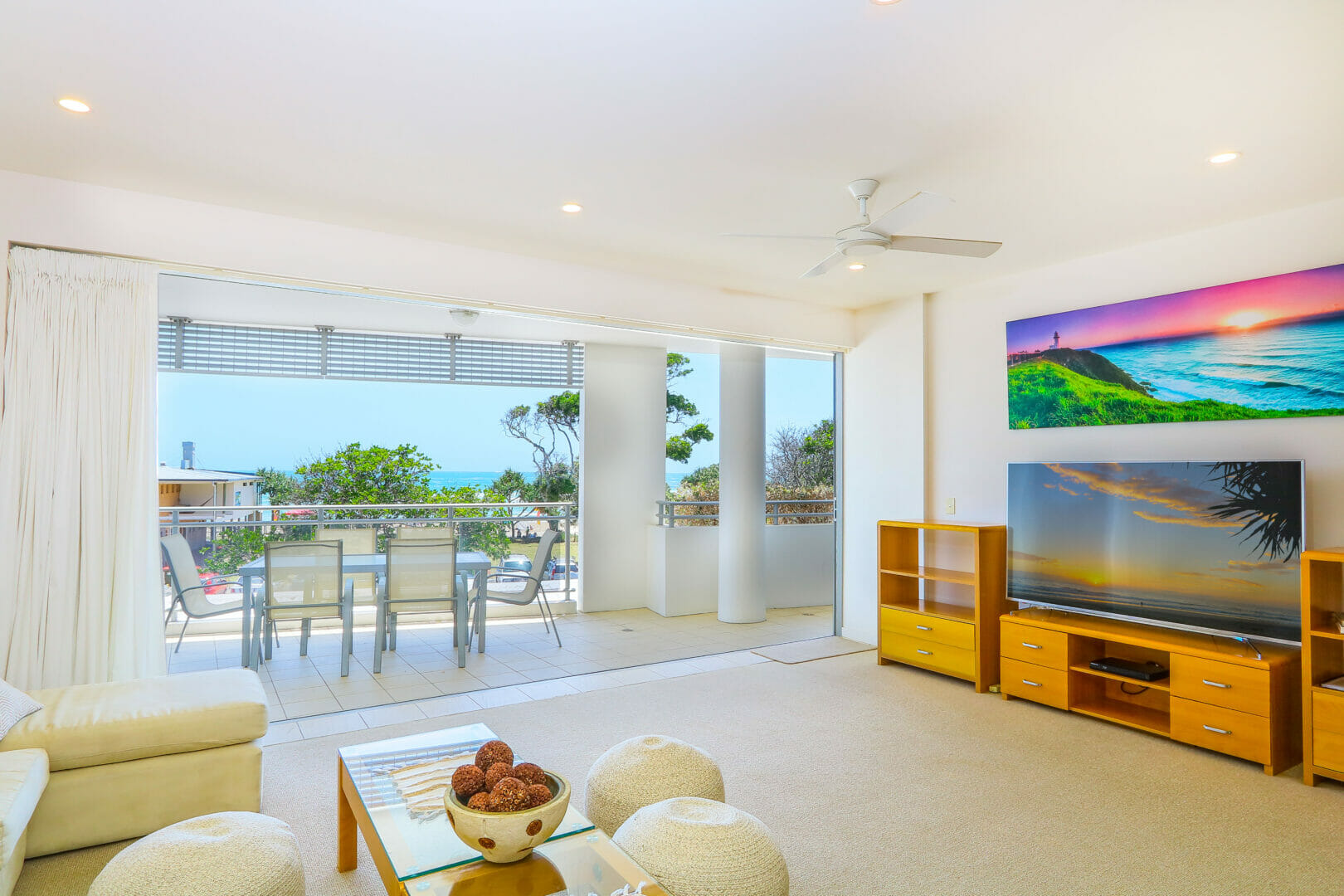 Apartment living room with television and ocean views