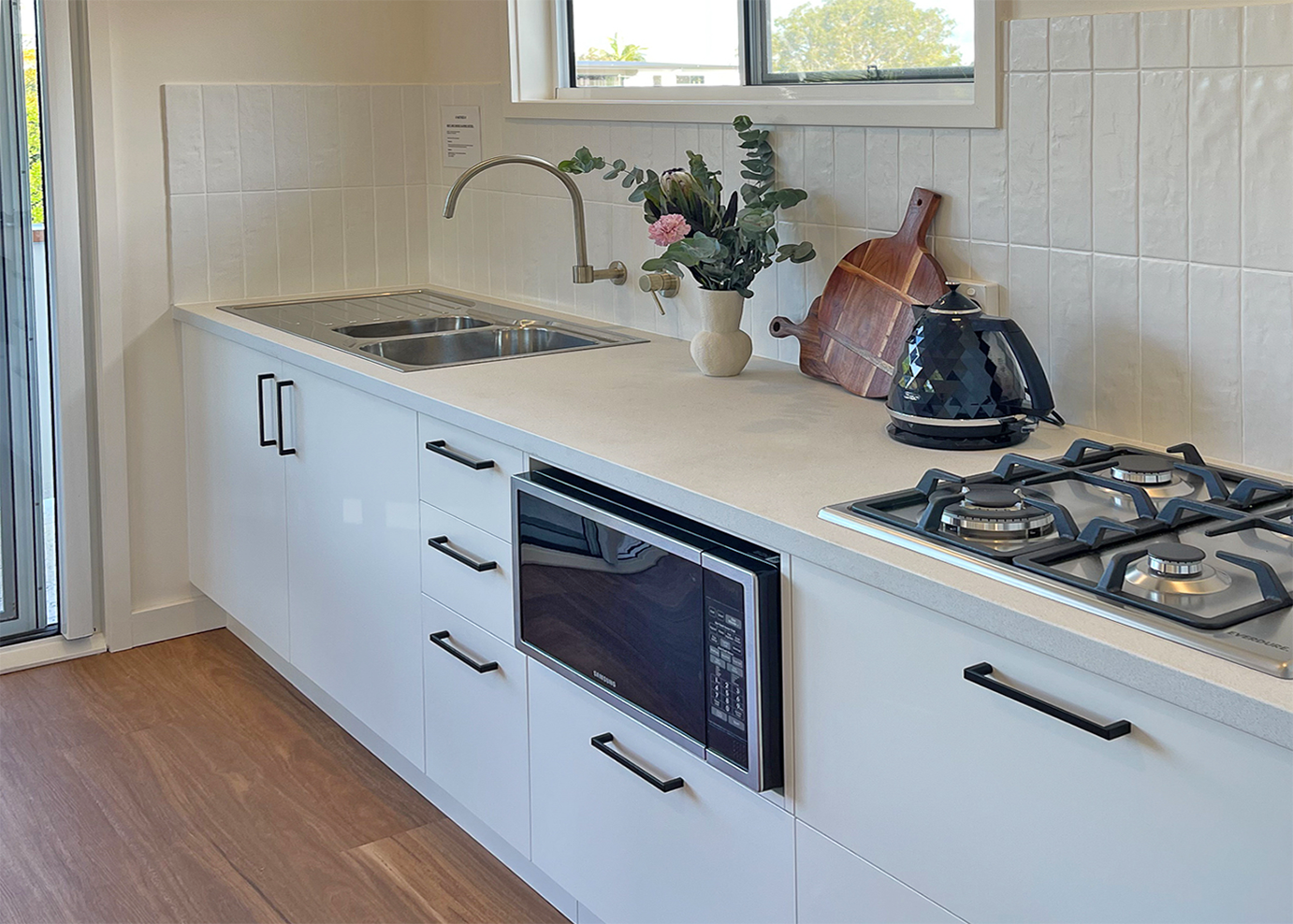 Galley kitchen with microwave and gas cooktop
